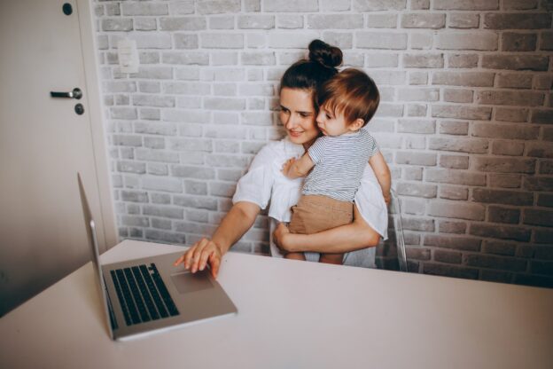 A woman and baby on a laptop computer